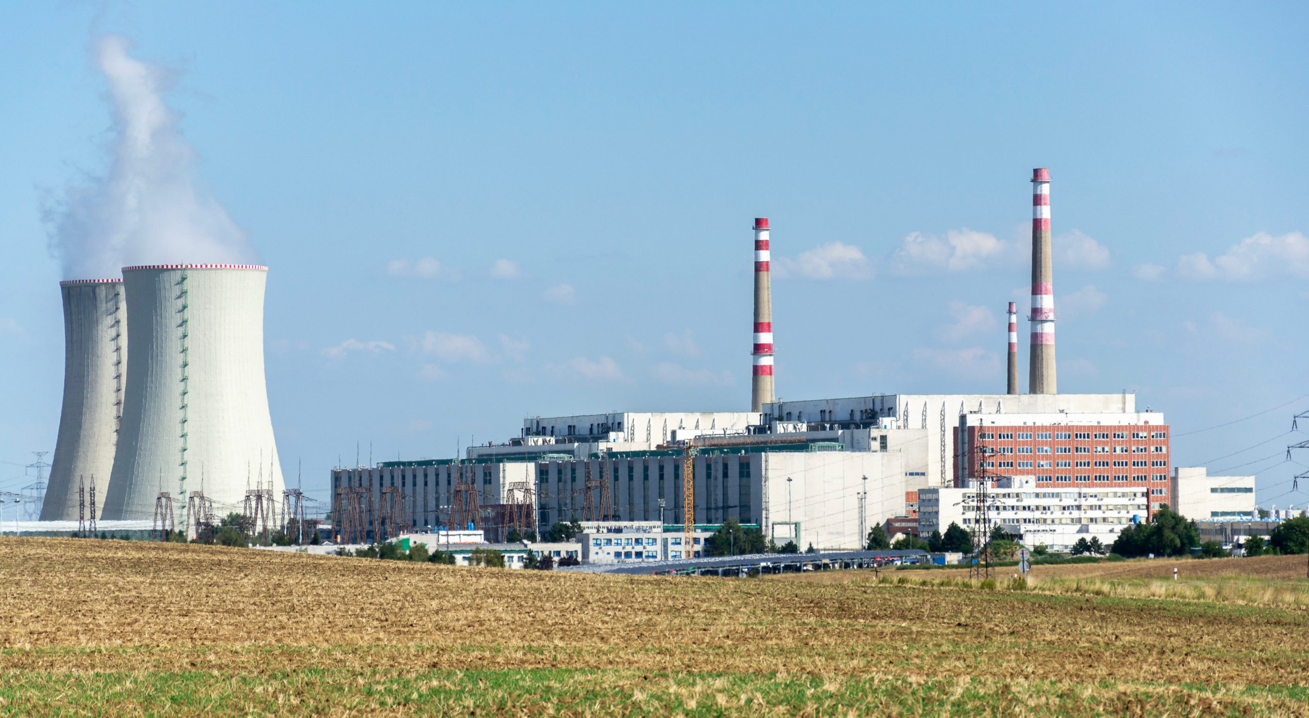 Cooling towers at nuclear power plant, energy self-sufficiency, greenhouse emission reduction and global warming concept Nuclear Power Plant