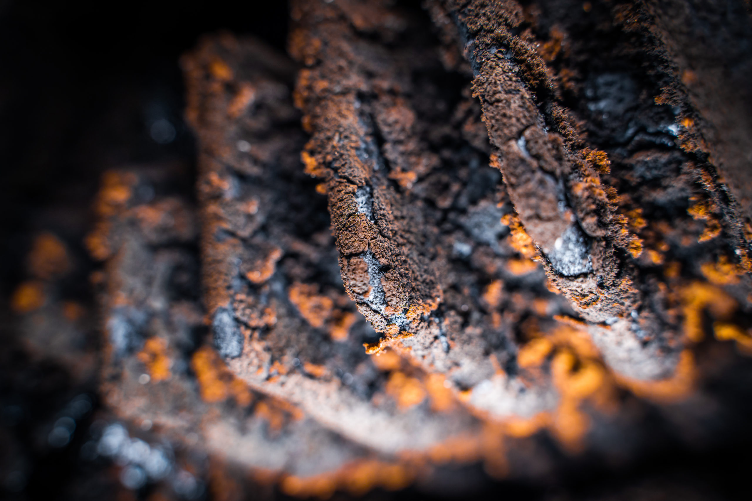 Tar and soot in the furnace of a solid fuel boiler after the heating season close-up Soot and tar build up on boiler